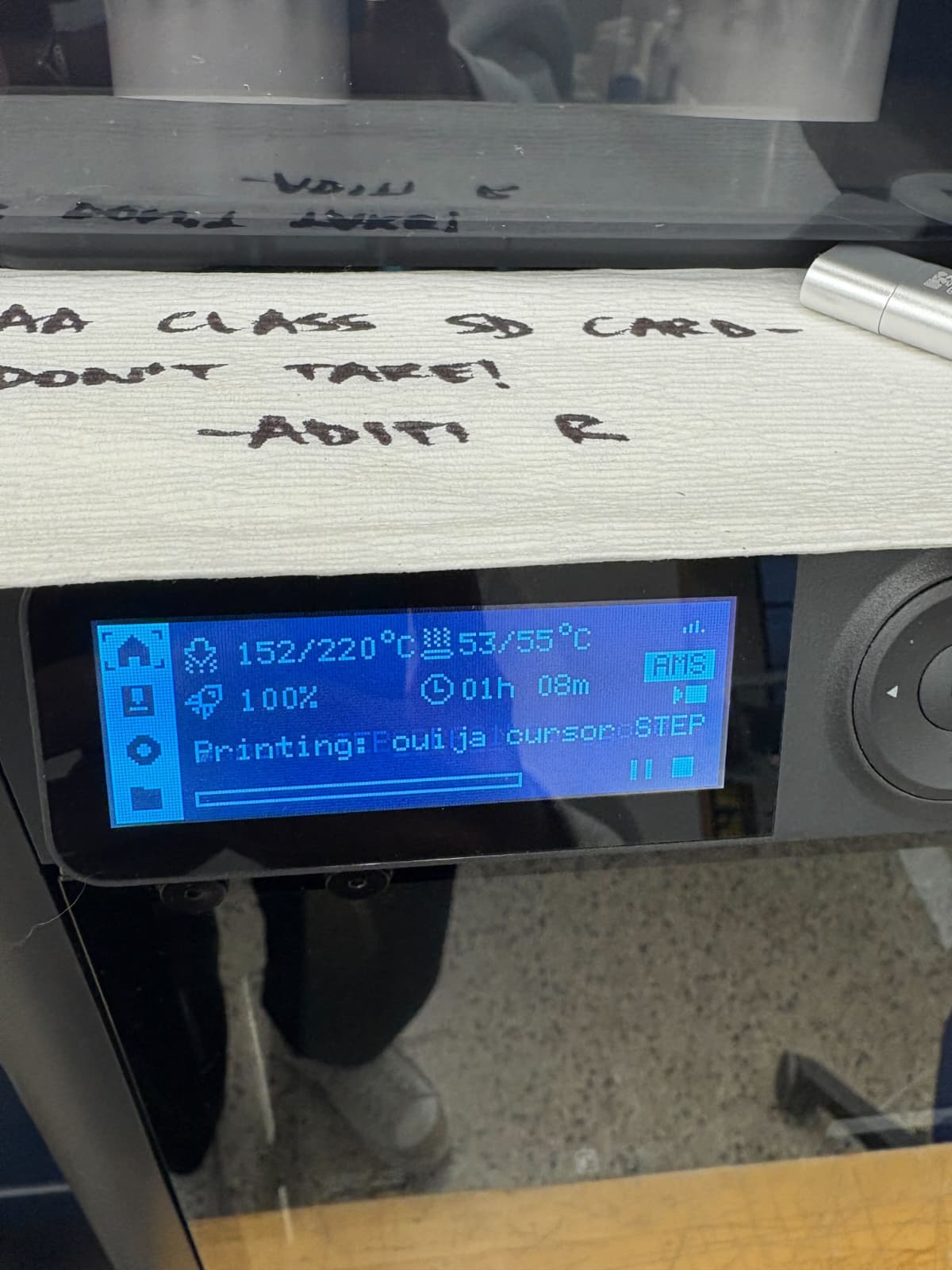 Team gathered around workbench testing the finished cursor